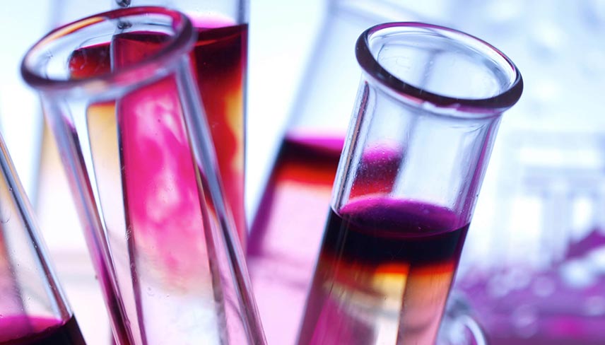 glass test tubes filled with pink liquid