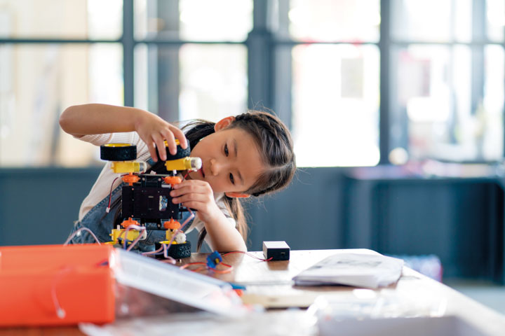 Child working on a robotic project