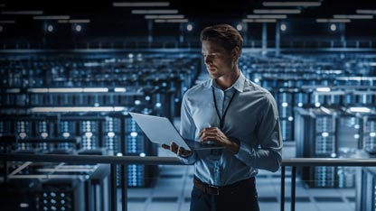 Un homme debout dans une salle de serveurs