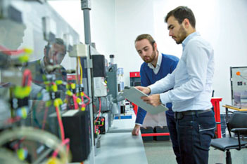 Two men consulting tablet in a laboratory