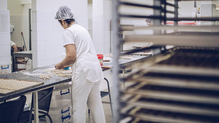 Worker making bread in a bakery