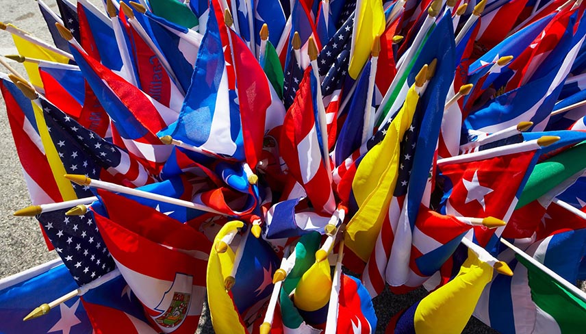 The image is a group of flags arranged in a pinwheel shape outdoors.