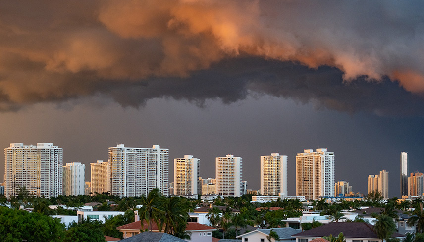 Dark storm clouds loom over the city skyline, creating a dramatic and ominous atmosphere