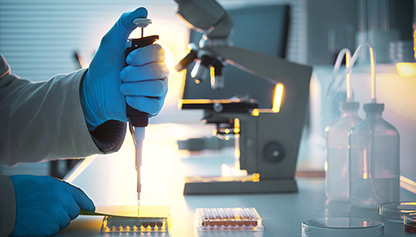 A scientist in a lab coat holds a test tube, conducting an experiment in a laboratory setting.