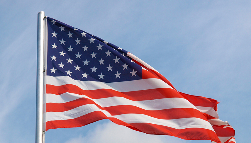 American flag with blue sky