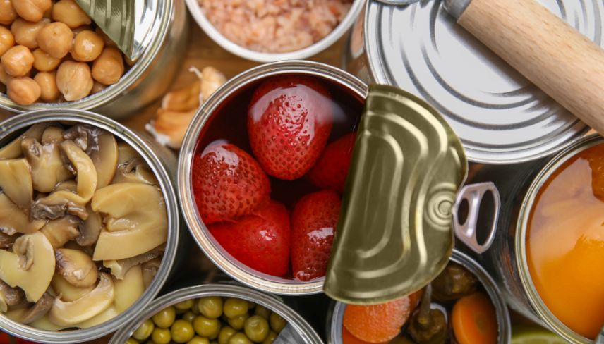 A variety of canned food items displayed, showcasing different types and labels in an organized arrangement.